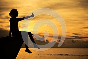 Happy teen girl sitting on beach