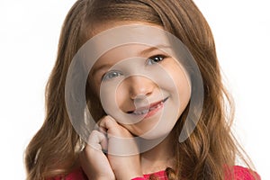 The happy teen girl standing and smiling against white background.