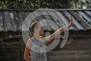 Happy teen girl in the summer rain
