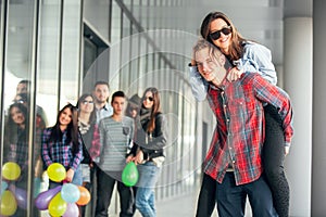 Happy teen girls and boys having good fun time outdoors.