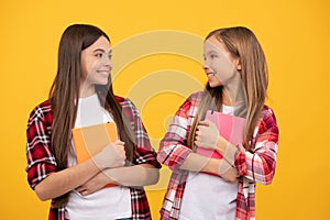 happy teen girls in casual checkered shirt with notebooks, sisterhood