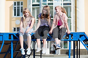 Happy teen girls on city street