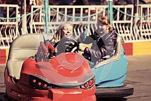 Happy teen girls driving a bumper cars