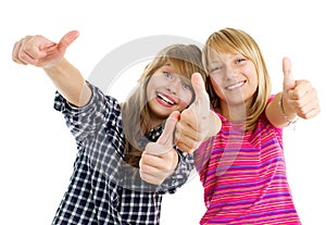 Happy teen girls showing thumbs up