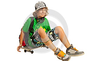 Happy teen sitting on skateboard