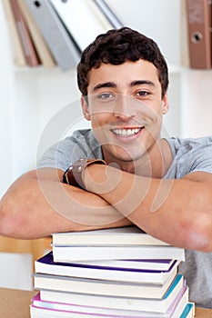 Happy teen studying a lot of books