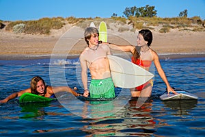 Happy teen surfers talking on beach shore