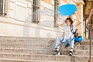 Happy teenage boy with blue blanked speech bubble