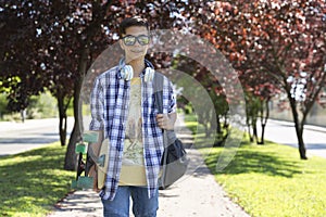 Happy teenage boy caucasian student going to high school. Outdoor portrait. Secondary education