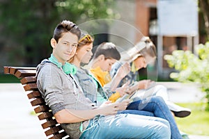 Happy teenage boy with tablet pc and headphones