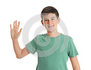 Happy teenage boy waving to say hello on white photo