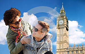 Happy teenage couple having fun over big ben tower