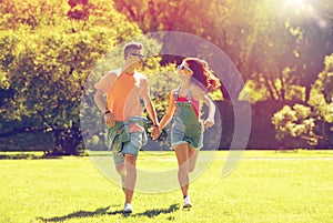 Happy teenage couple running at summer park