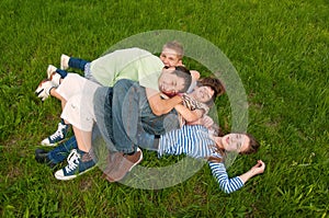 Happy teenage friends having fun in the grass