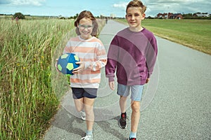 Happy teenage friends joyful walking at summer holidays