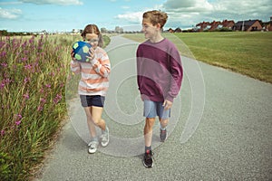 Happy teenage friends joyful walking at summer holidays