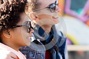 Happy teenage friends in shades outdoors