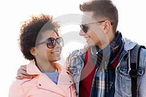 Happy teenage friends in shades talking outdoors