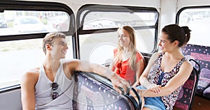 Happy teenage friends traveling by bus