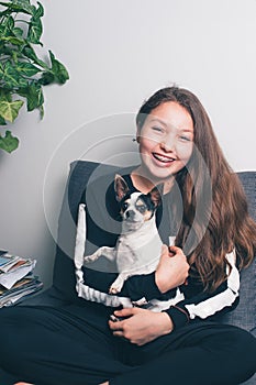 Happy teenage girl with brace at Home with dog