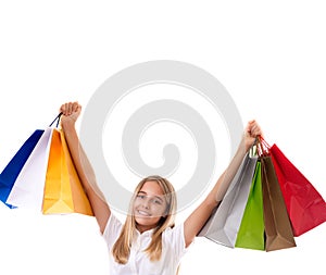 Happy teenage girl in casual clothing with shopping bags, isolated