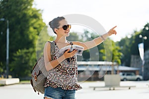 Happy teenage girl with guidebook and backpack