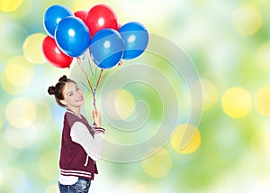 Happy teenage girl with helium balloons