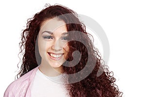 Happy teenage girl with long curly hair and toothy smile photo