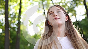 happy teenage girl portrait in the park. teenager wants a dream portrait at sunset. woman daughter silhouette dreams of