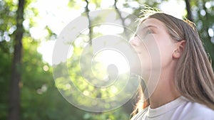 happy teenage girl portrait in the park. teenager wants a dream portrait at sunset. woman daughter silhouette dreams a