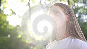 Happy teenage girl portrait in the park. Teenager wants a dream portrait at sunset. Woman daughter silhouette dreams a