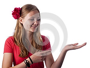 Happy teenage girl showing something on the palm of her hand