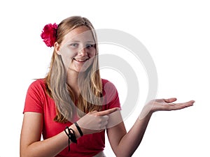 Happy teenage girl showing something on the palm of her hand