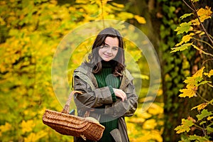 Happy teenage girl smiling. Autumn portrait of a beautiful young girl holds basket.