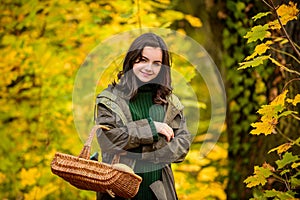 Happy teenage girl smiling. Autumn portrait of a beautiful young girl holds basket.