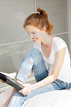 Happy teenage girl with tablet pc computer