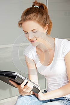 Happy teenage girl with tablet pc computer