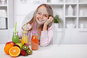 Happy teenage girl with a variety of healthy fresh fruit juices