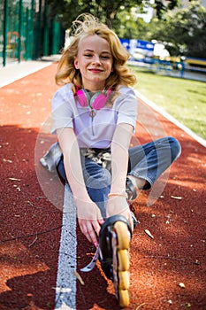 Pretty Teenage Girl Wearing Roller Skaters On The Road In Summe Park. photo