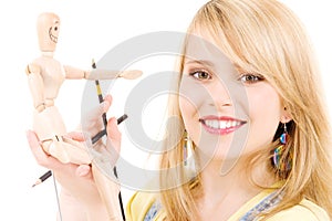 Happy teenage girl with wooden model dummy