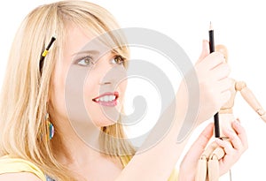 Happy teenage girl with wooden model dummy