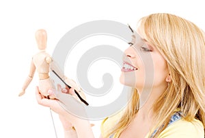 Happy teenage girl with wooden model dummy