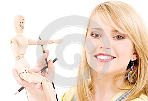 Happy teenage girl with wooden model dummy