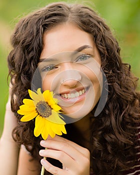 Happy teenage high school senior girl in sunflower field