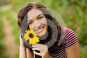 Happy teenage high school senior girl in sunflower field