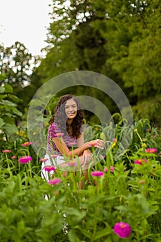 Happy teenage high school senior girl in sunflower field