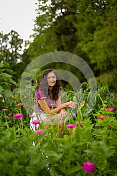 Happy teenage high school senior girl in sunflower field