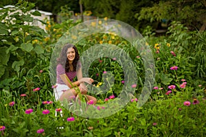 Happy teenage high school senior girl in sunflower field