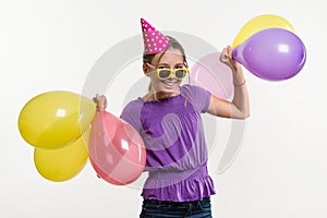 Happy teenage party girl 12-13 years old with balloons.