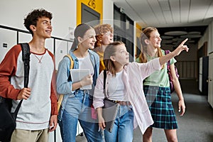 happy teenage schoolkids looking away in